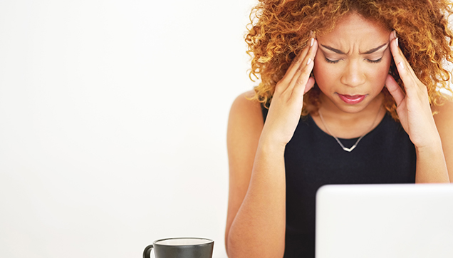 A stressed woman looking at a computer
