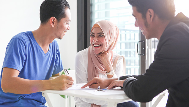 A group talking and laughing in an office