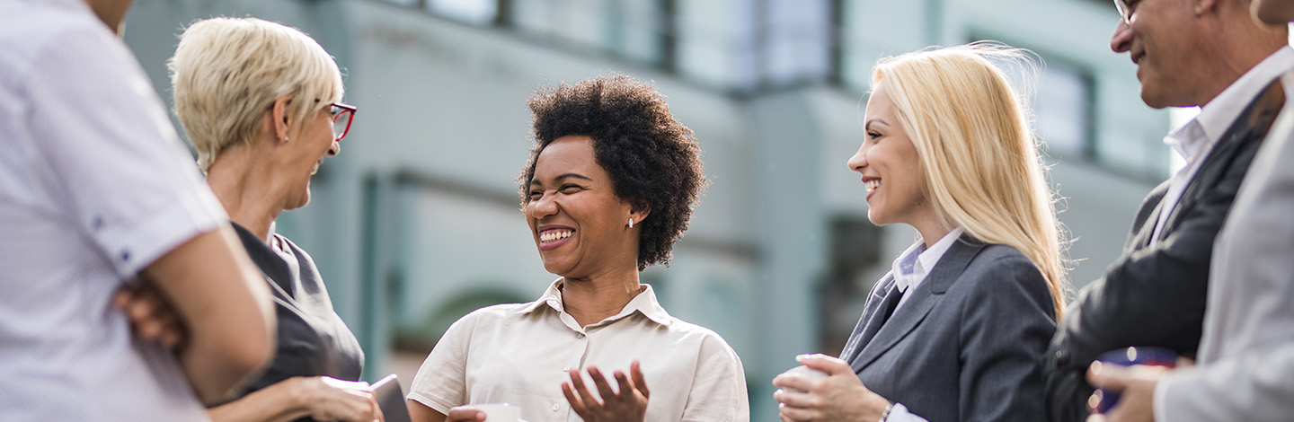 A group of employees laughing outside