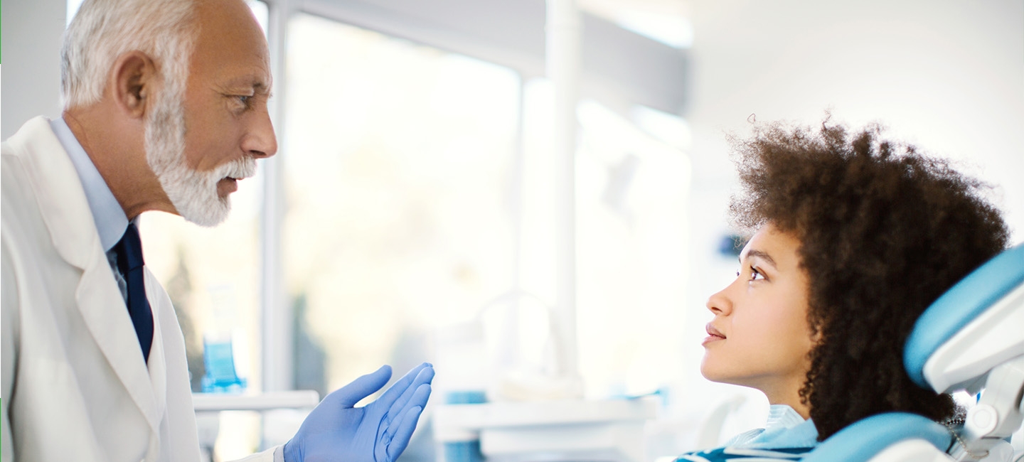 A dentist talking with a patient