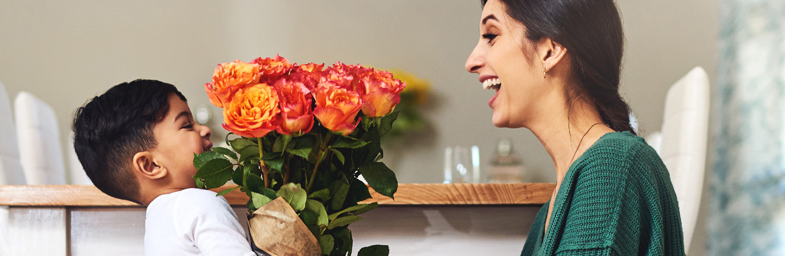 A child giving his mother flowers