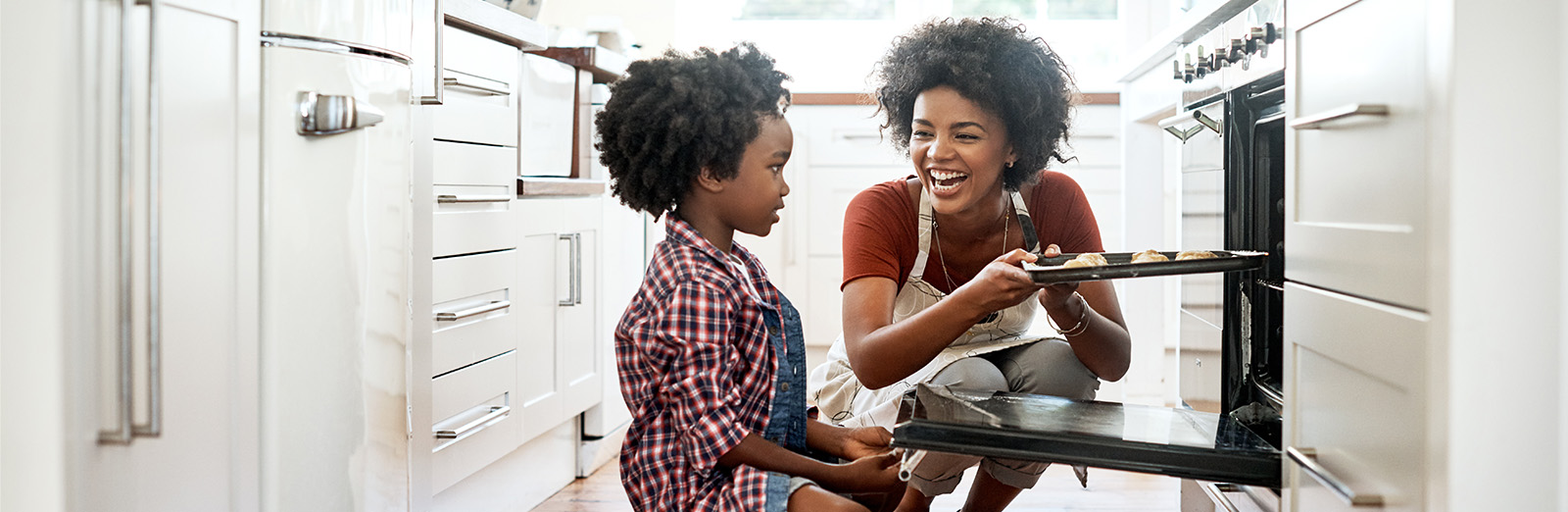 A mother and daughter baking in a kitchen