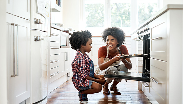A mother and daughter baking in a kitchen