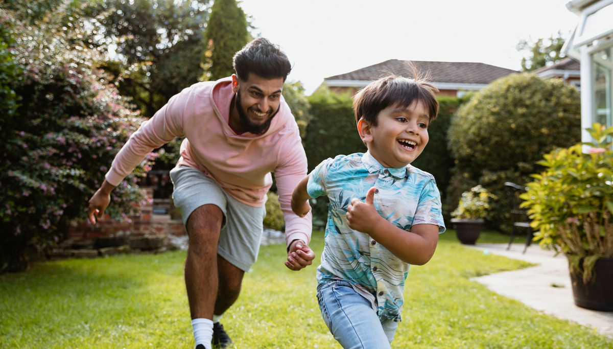 A father playing with his son in their backyard