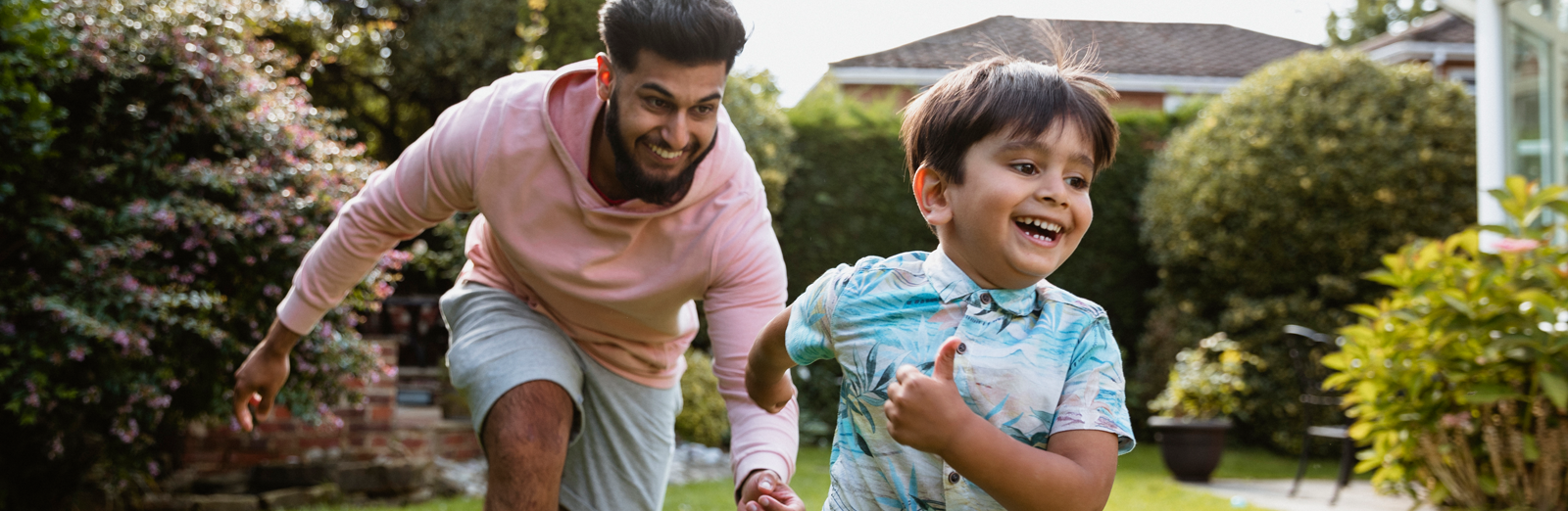 A father playing with his son in their backyard