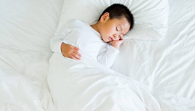 A child sleeping in a bed