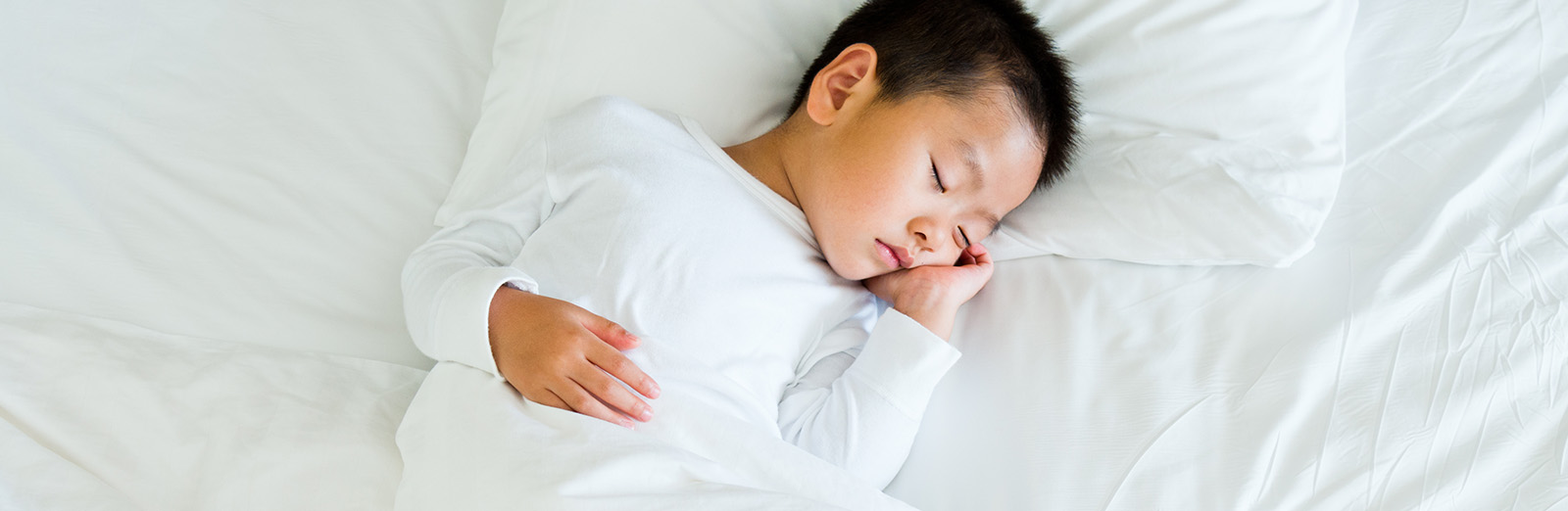 A child sleeping in a bed