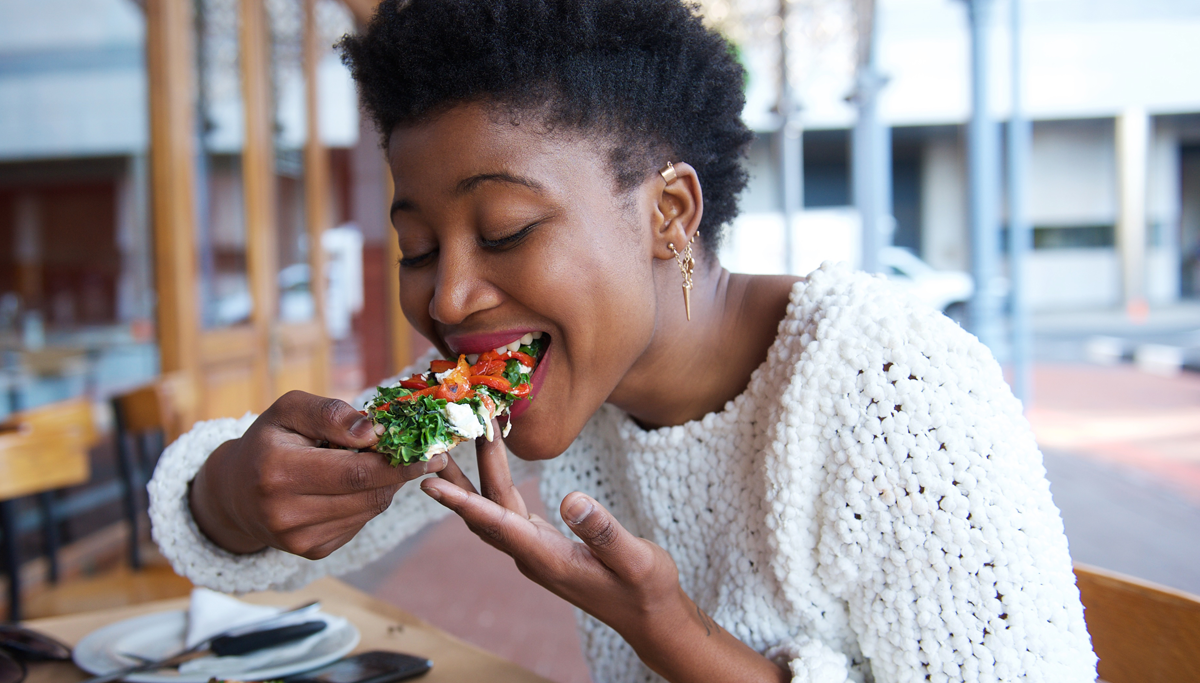 A woman eating vegetables