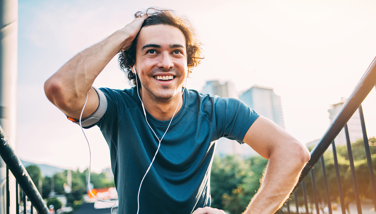 A man smiling while exercising outside