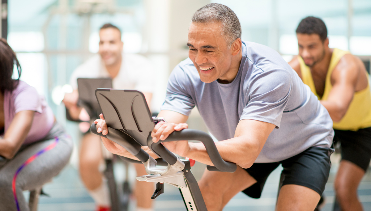 A man exercising in a spinning class