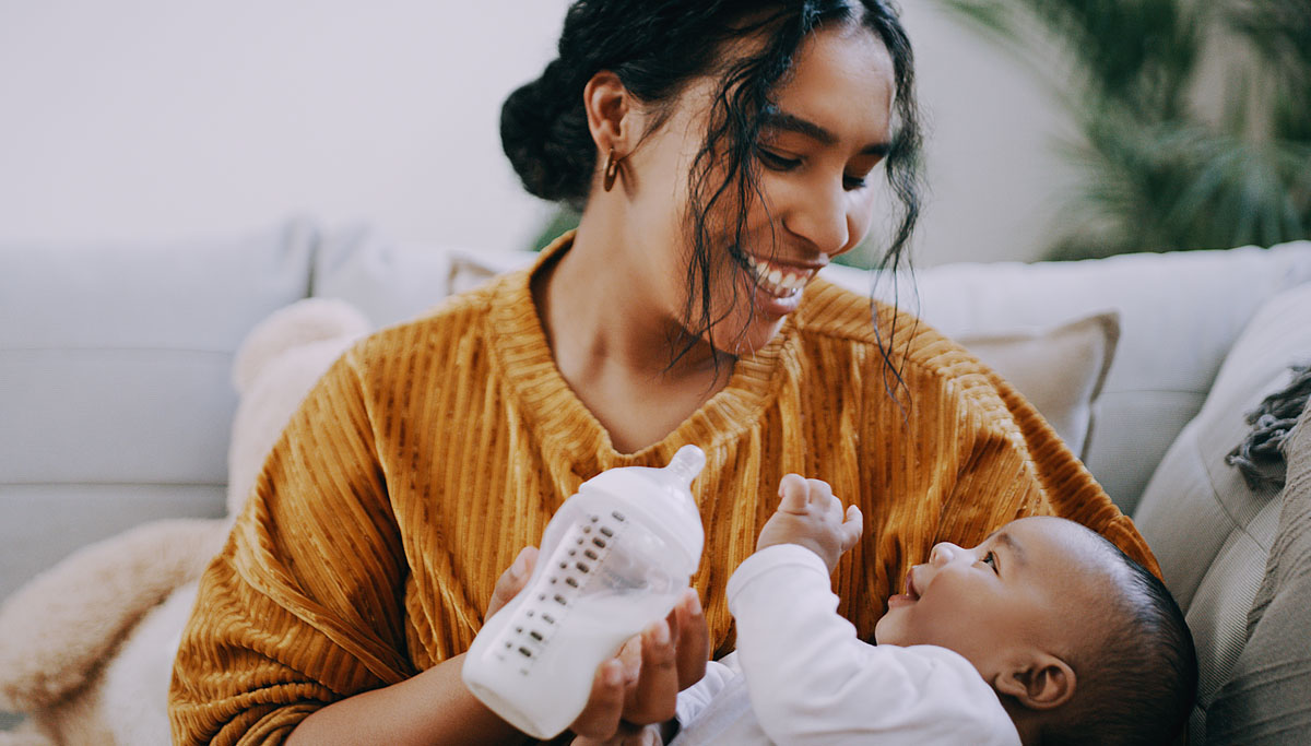 A mother feeding a baby with a bottle