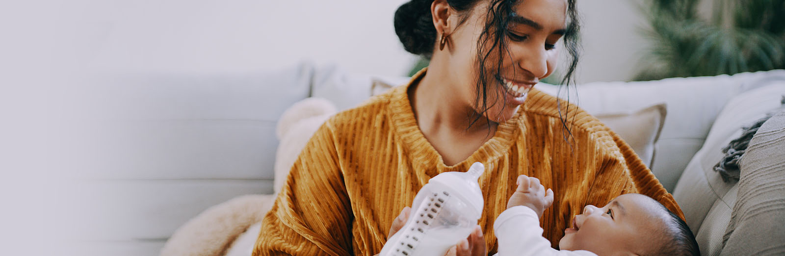 A mother feeding a baby with a bottle