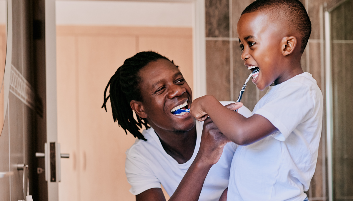 A father and son brushing their teeth