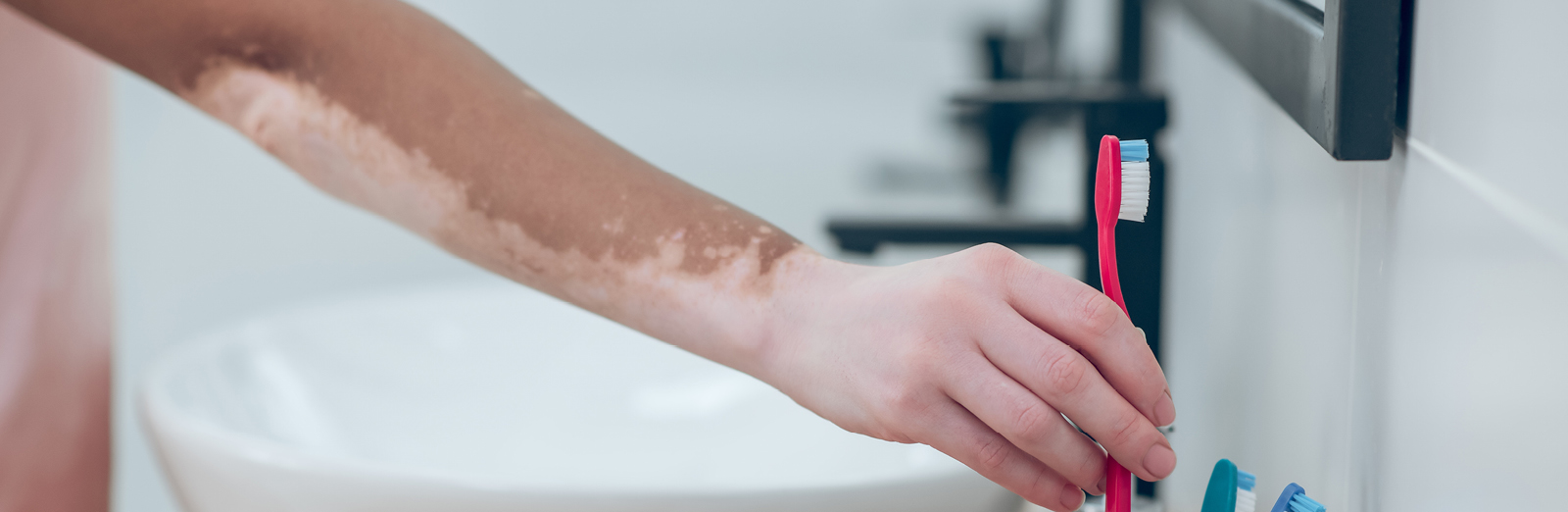 A person putting a toothbrush away