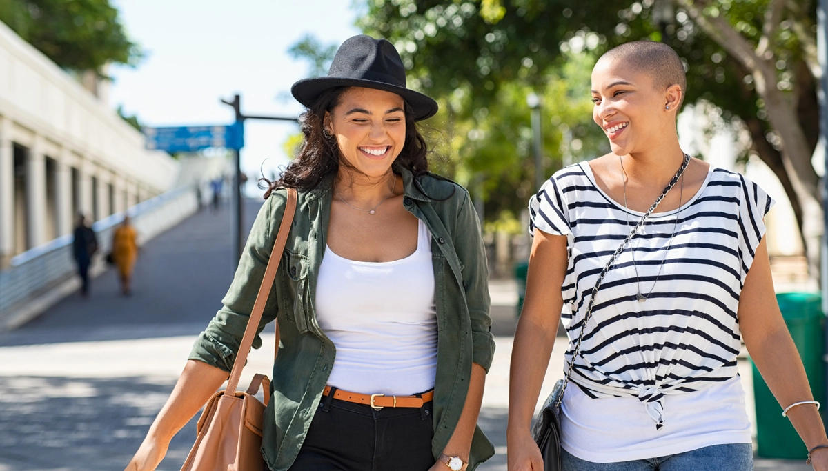 Two women walking down the street talking