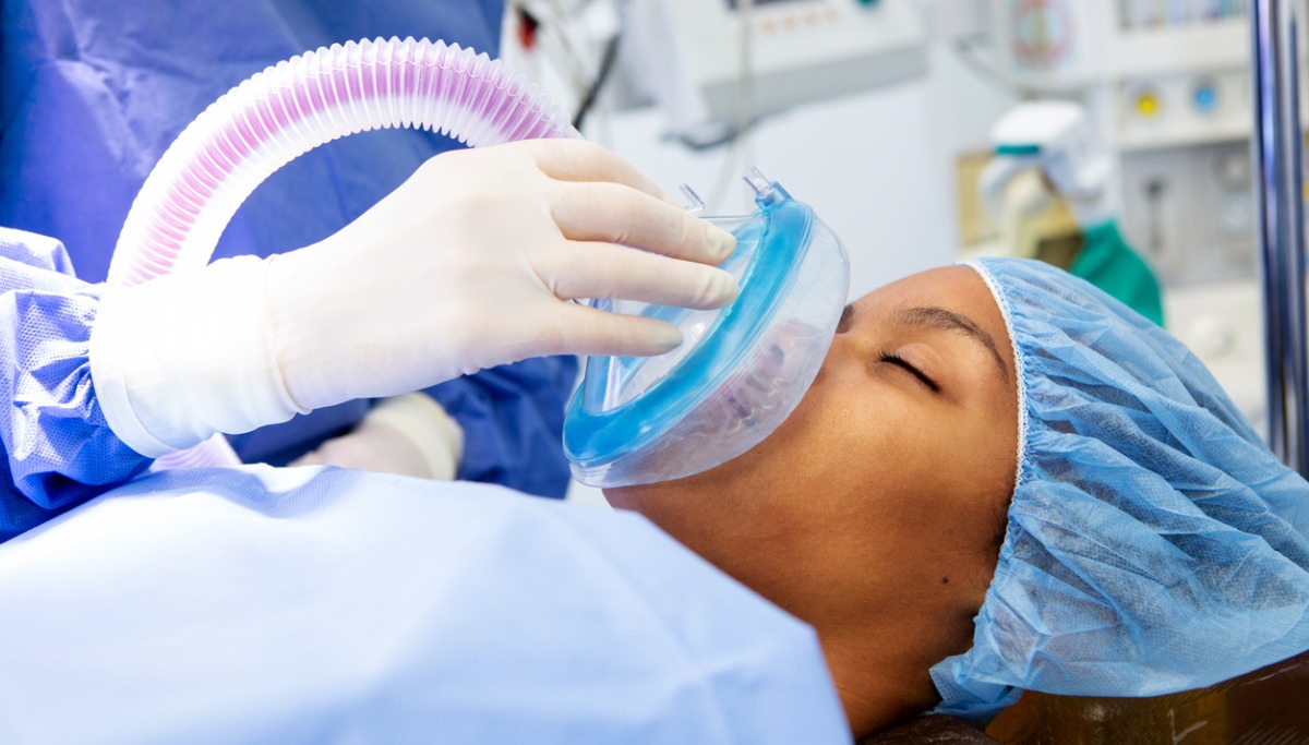 A patient receiving analgesia from a mask