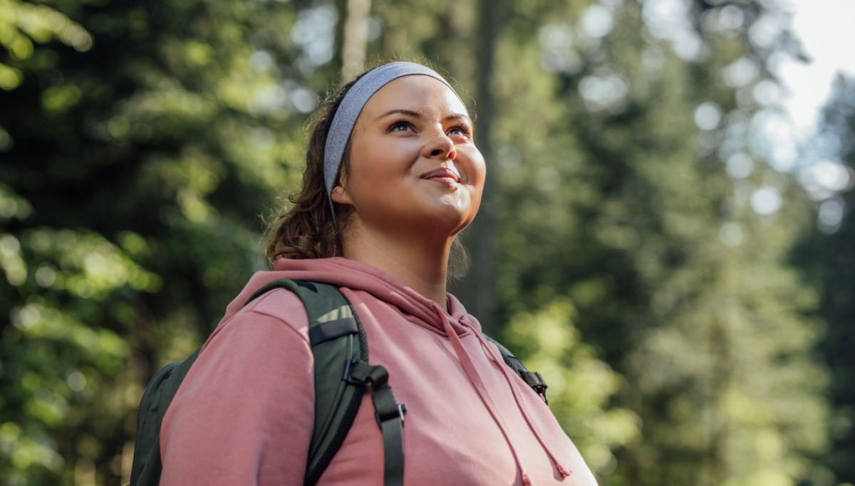 A woman smiling while out hiking in the sun