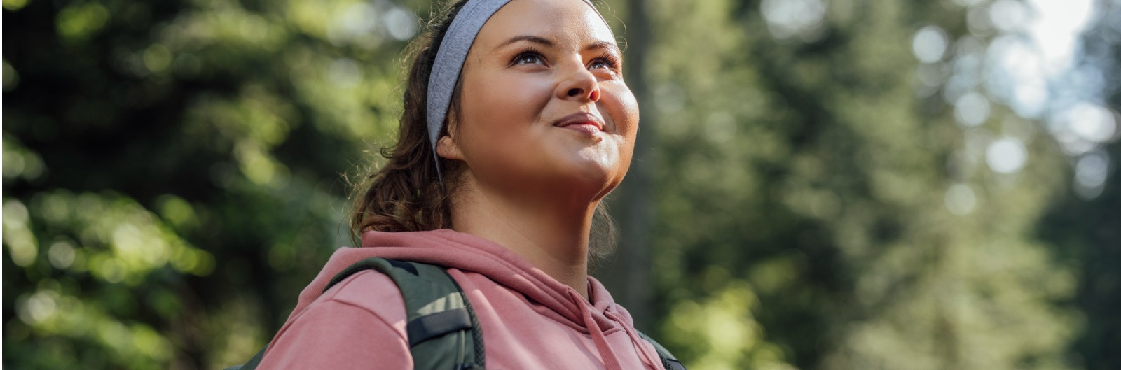 A woman smiling while out hiking in the sun