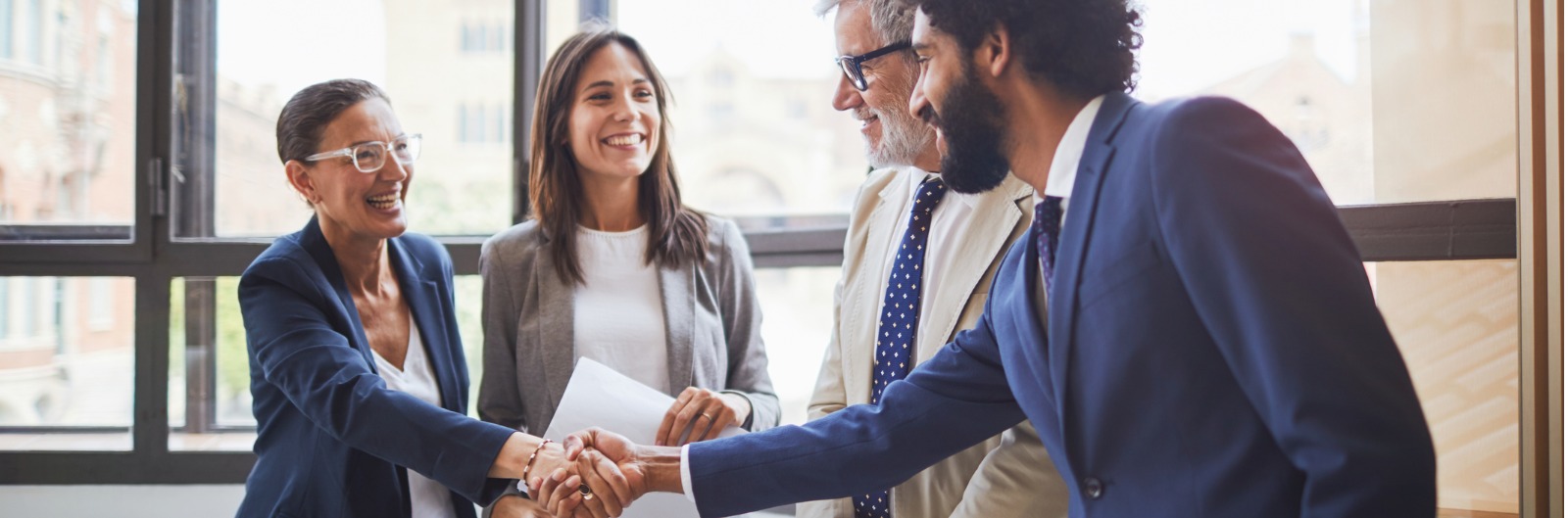 Two people in business attire shaking hands