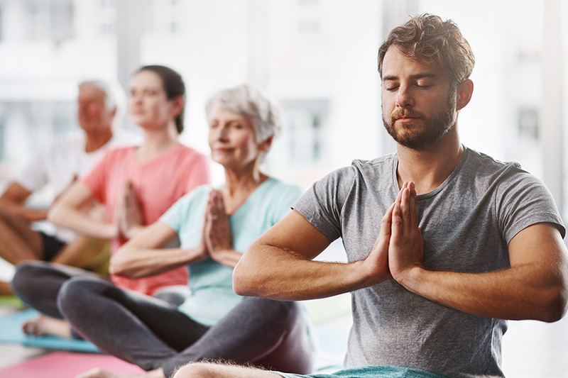 A group of people doing yoga