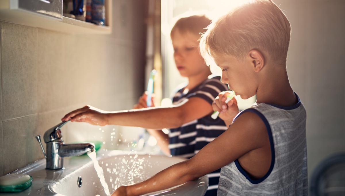 Two children brushing their teeth
