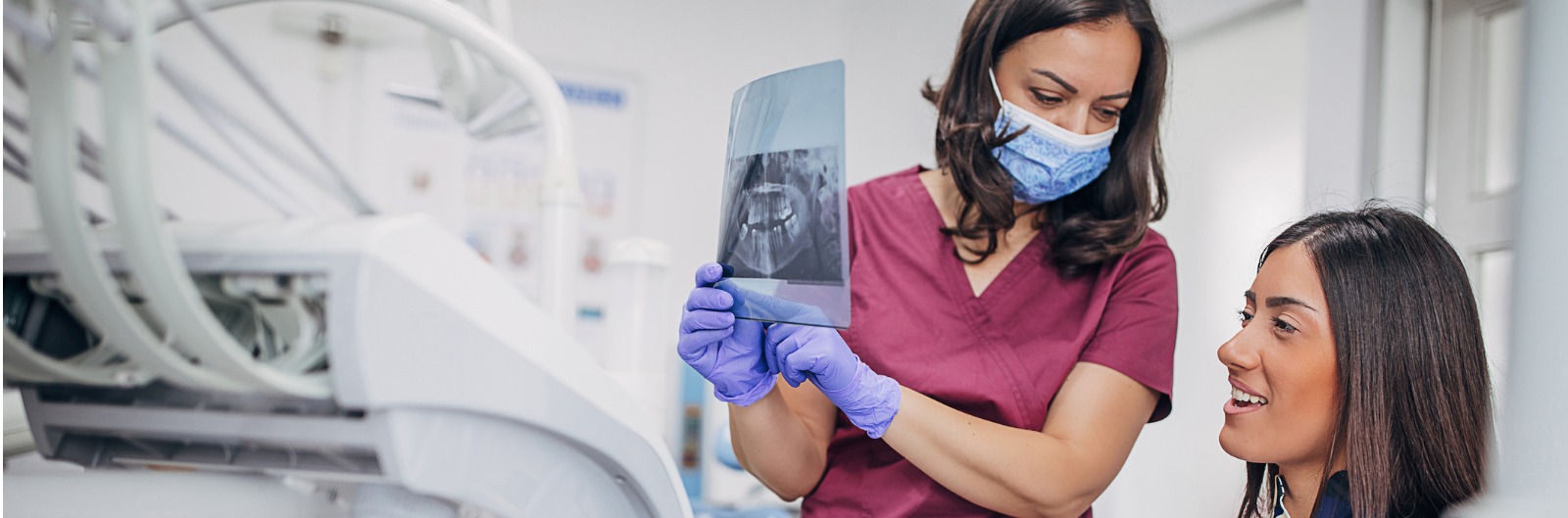 A dentist showing a patient a tooth x-ray