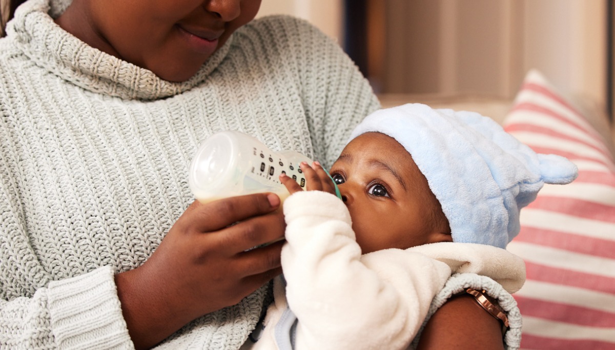 A mother feeding a baby with a bottle