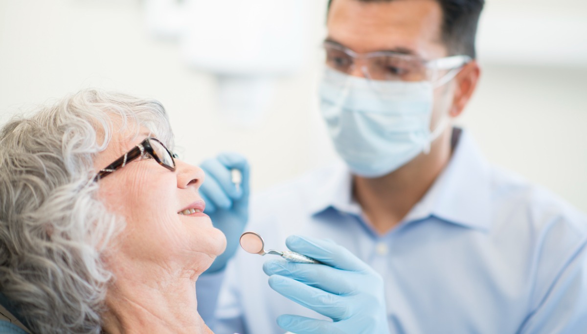 A dentist conducting an exam on a patient
