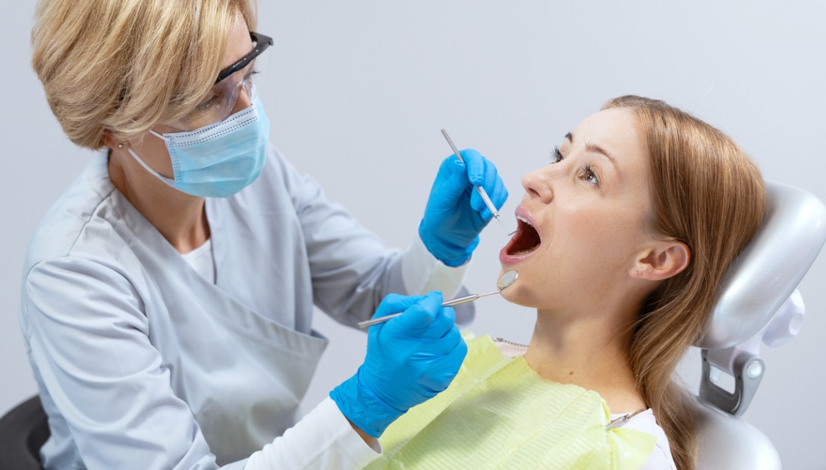 A dentist conducting an exam on a patient