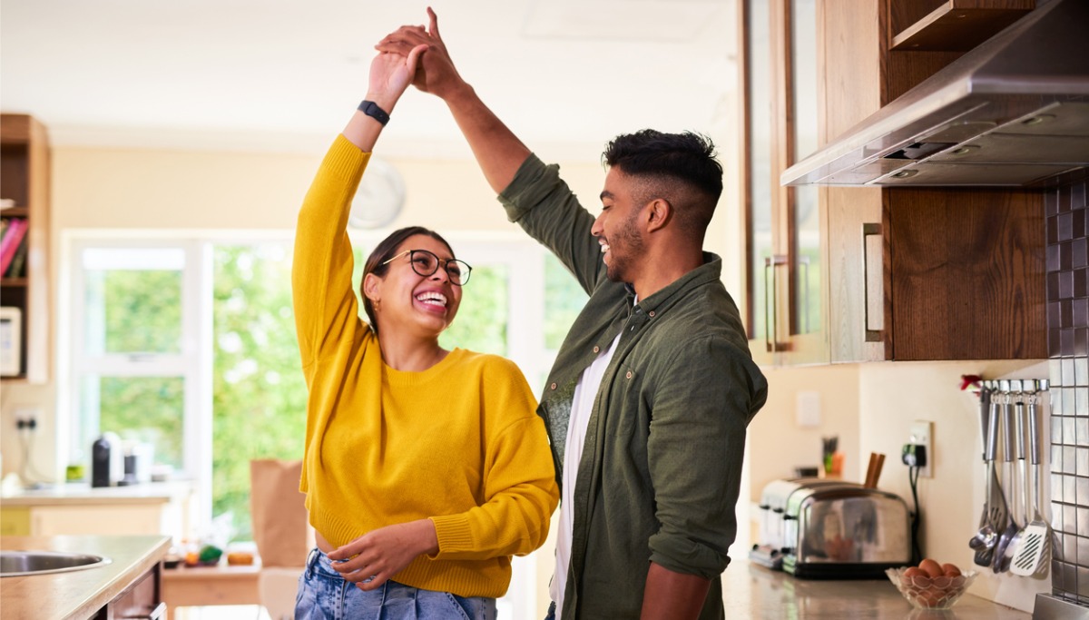 A couple dancing in their kitchen