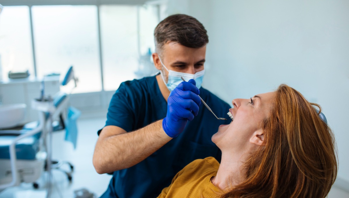 A dentist conducting an exam on a patient