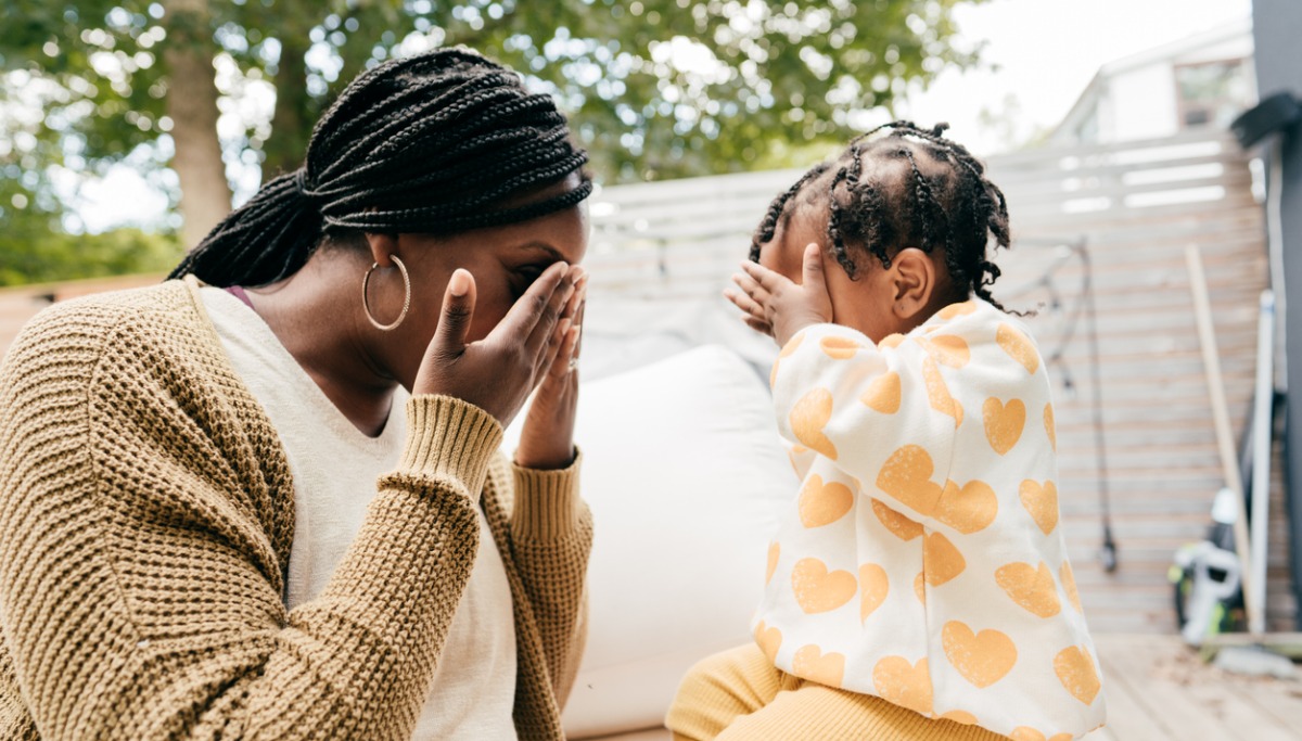 A mother and daughter playing peek-a-boo