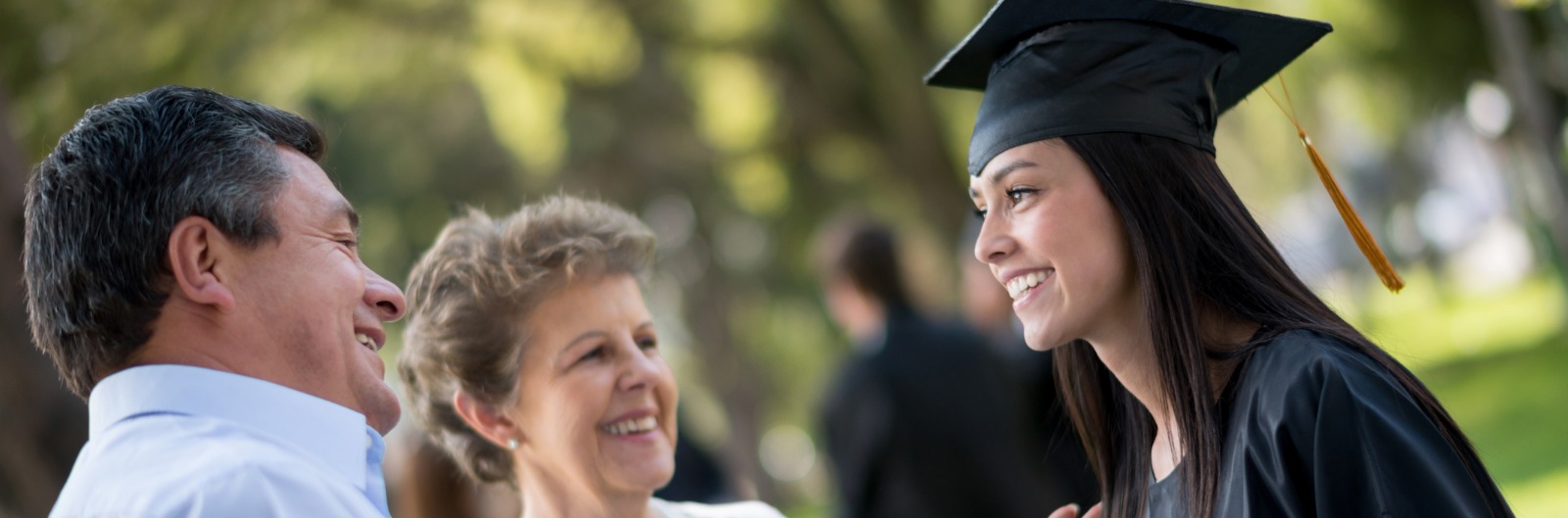A young woman who just graduated is celebrating with her family.