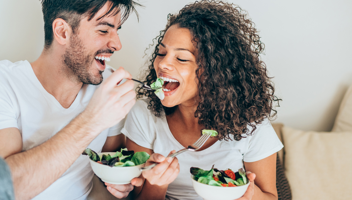 A couple eating salad together