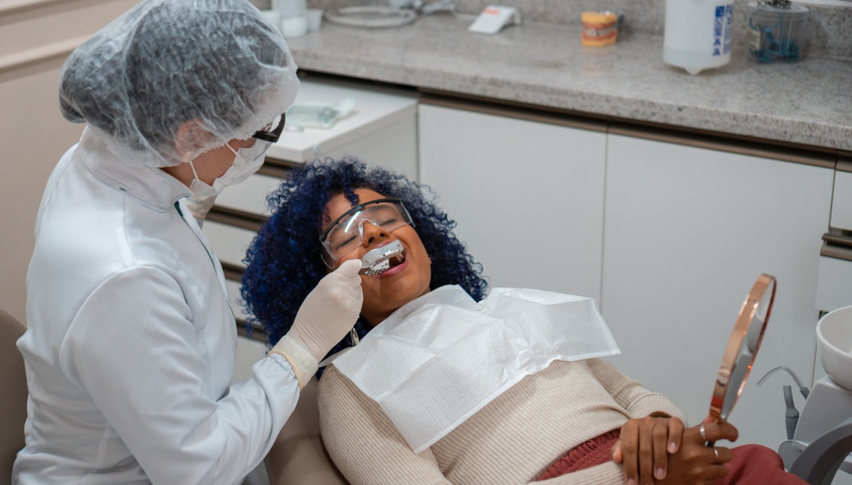 A dentist creating a mold of a patient's teeth
