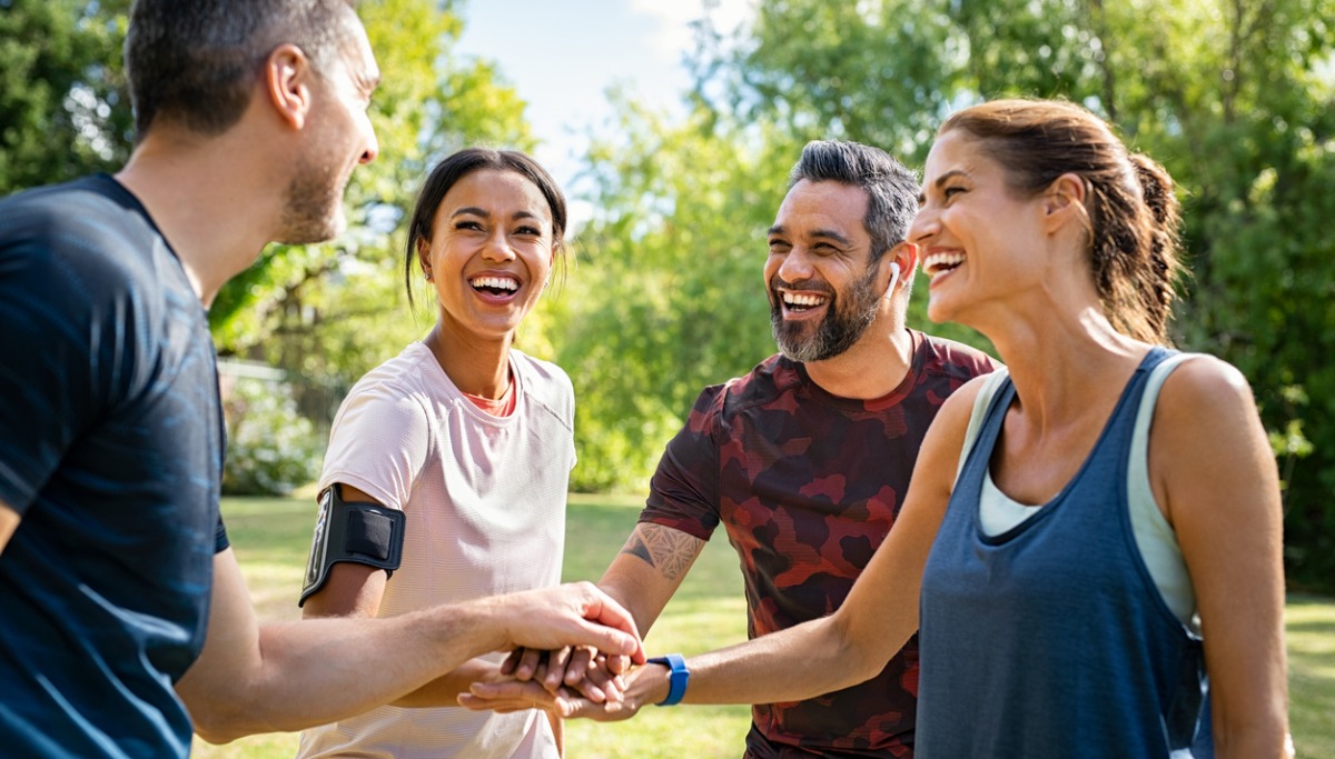 A group of people in a huddle stacking hands