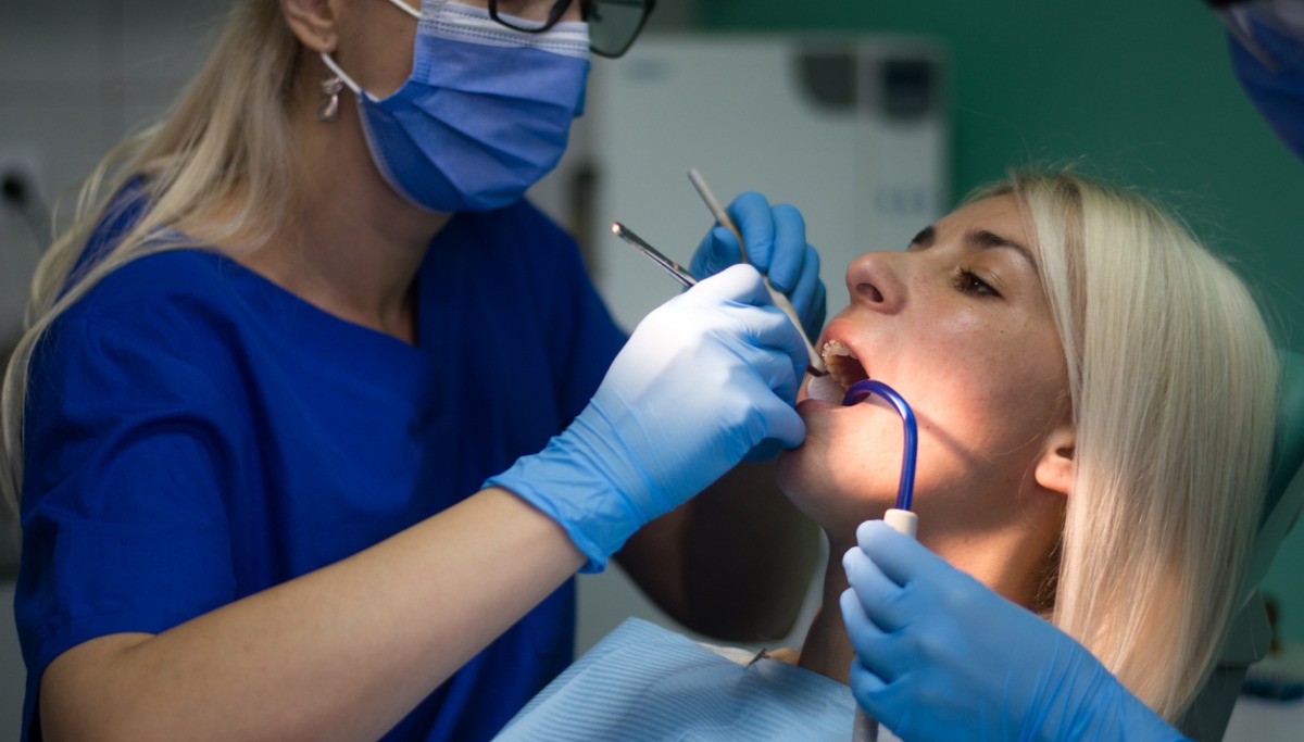 A dentist conducting an exam on a patient