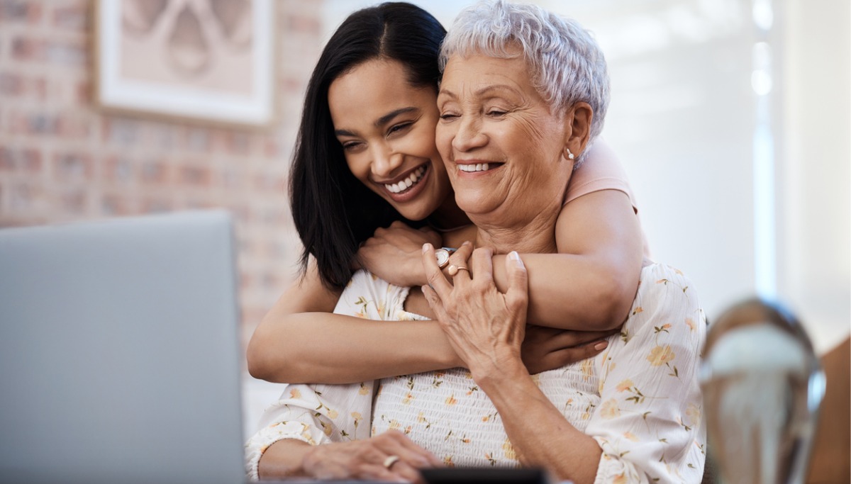 A daughter hugging her older mother