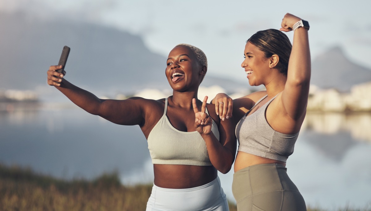 Two women taking a selfie outside while exercising