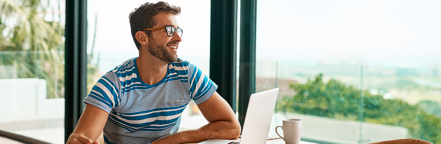 An employee sitting at desk smiling