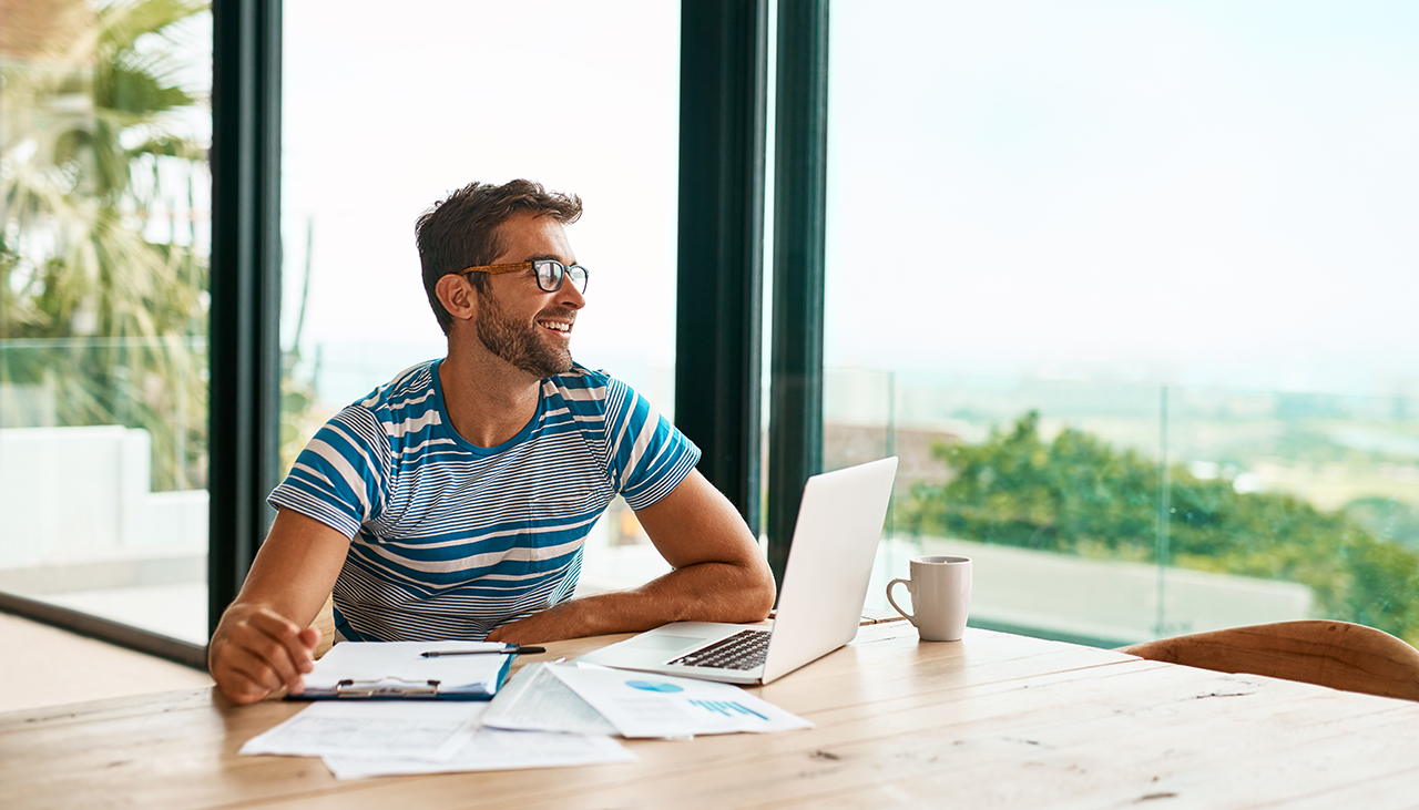 An employee sitting at desk smiling