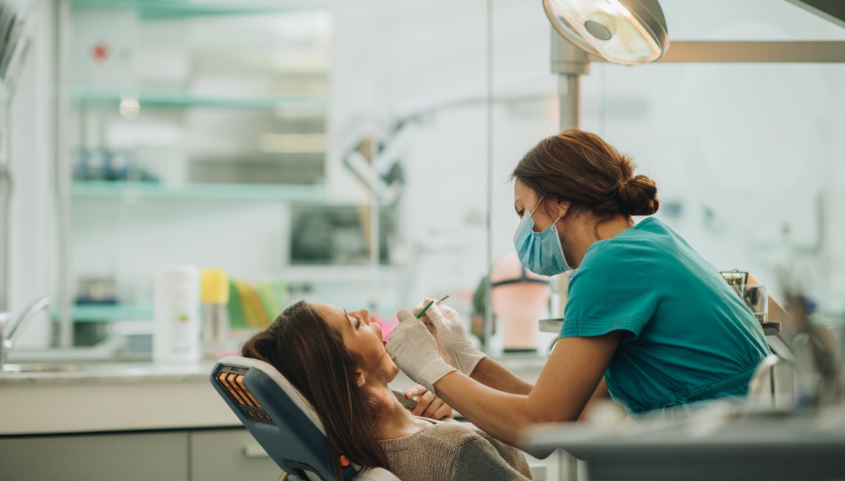 A dentist conducting an exam on a patient