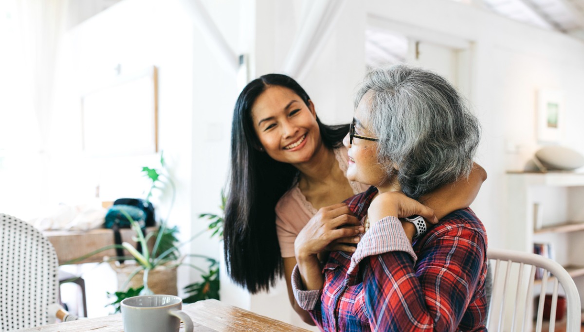 A woman hugging her older mother