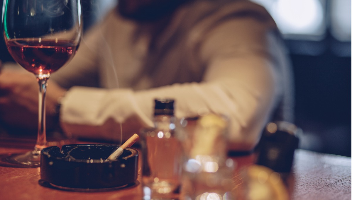 A cigarette burning in an ash tray
