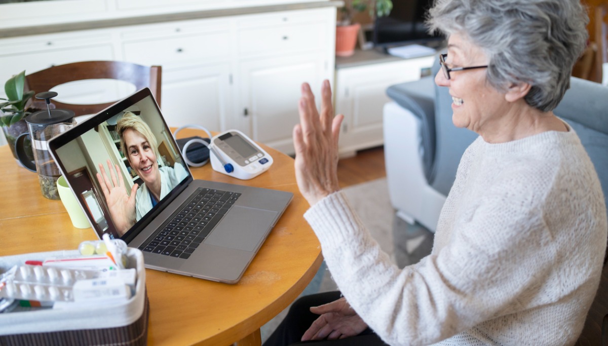 A woman and dentist talking via a laptop