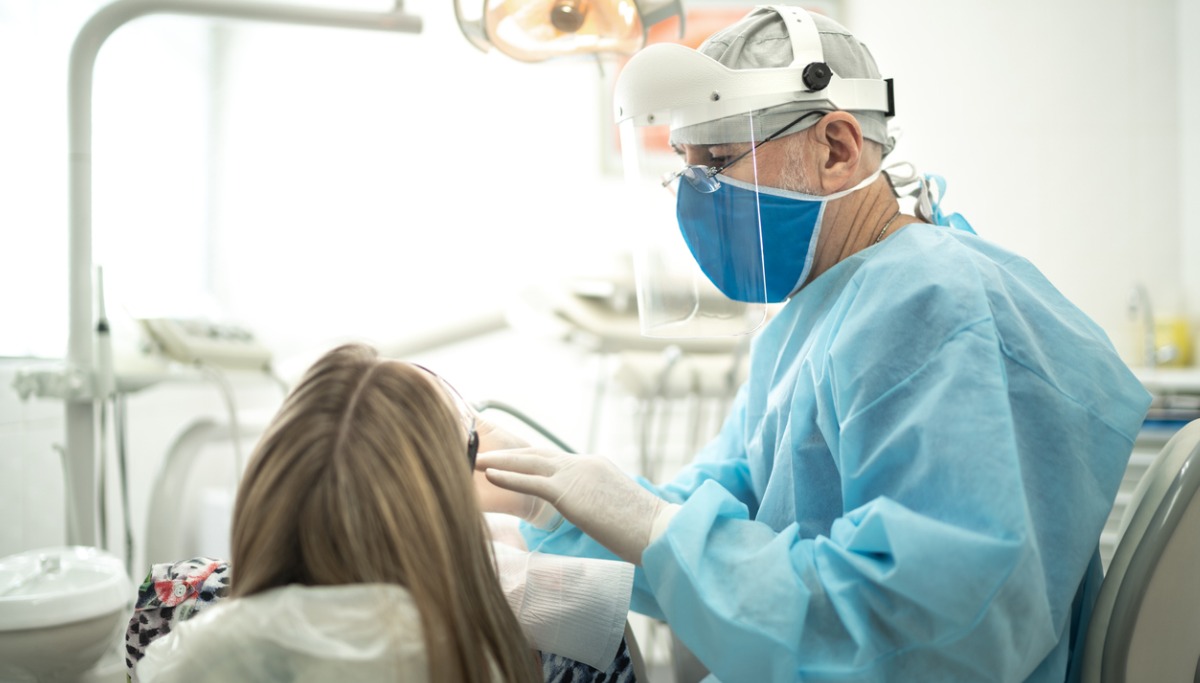 A dentist conducting an exam on a patient