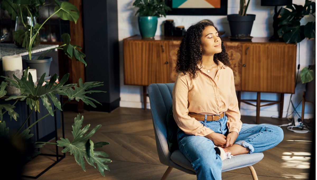 A woman sitting in an office soaking up the sun