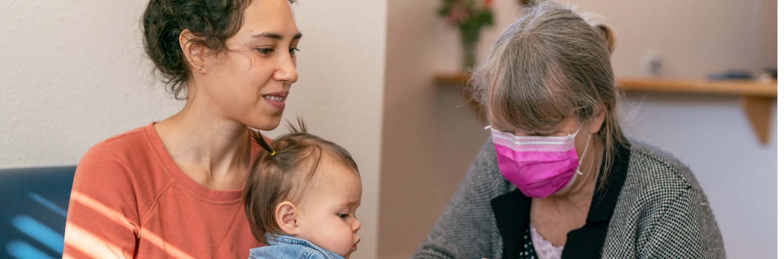 A mother and childen sitting with office staff