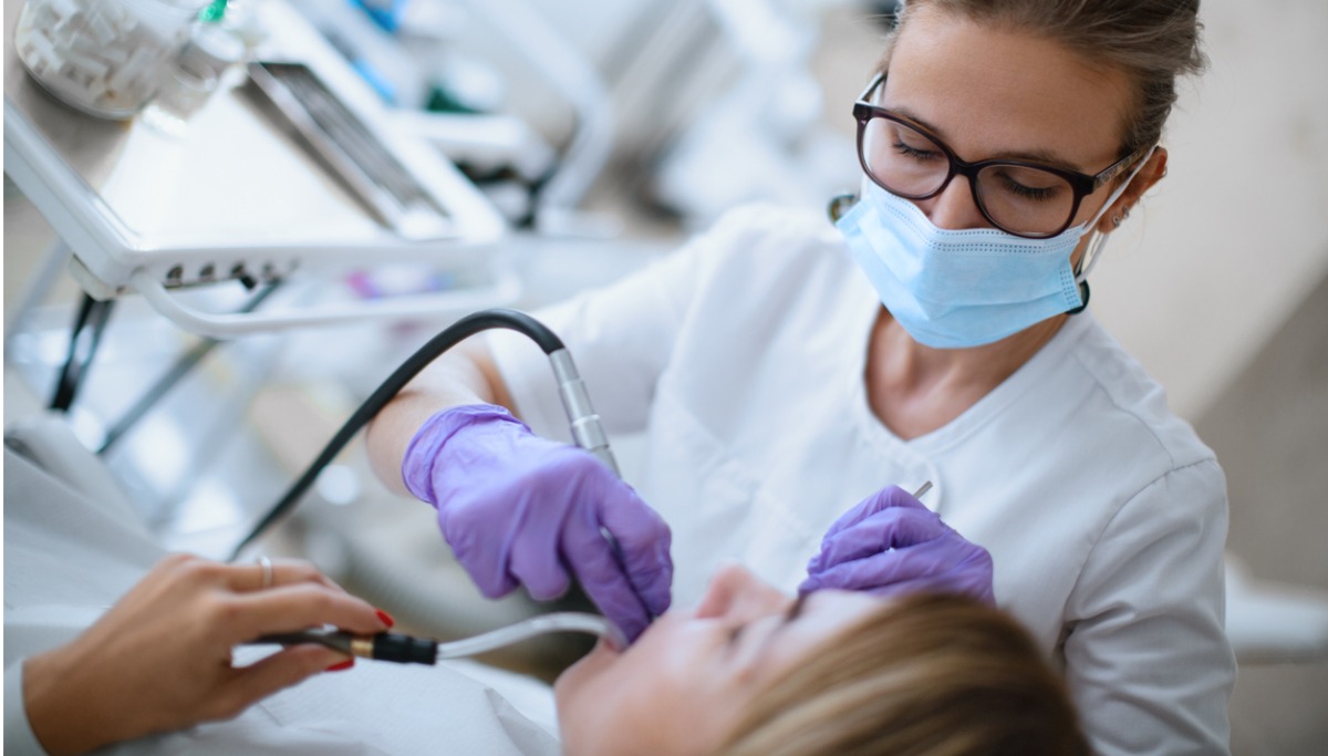 A dentist conducting a tooth filling