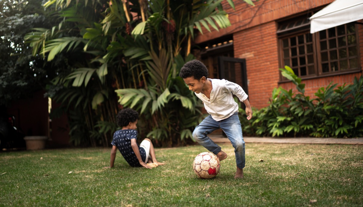 Two kids playing soccer